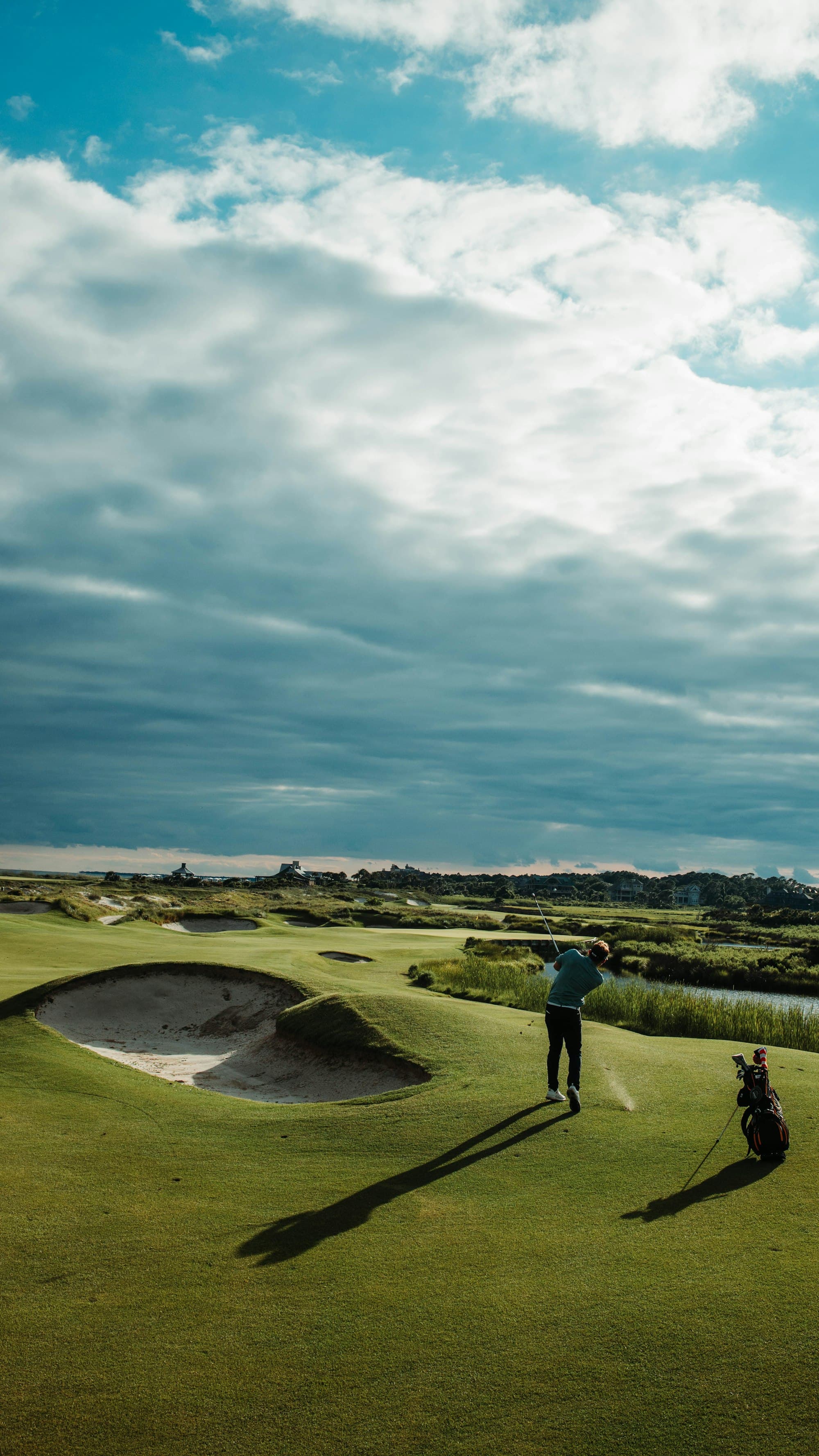 Golfer swinging on a coastal course